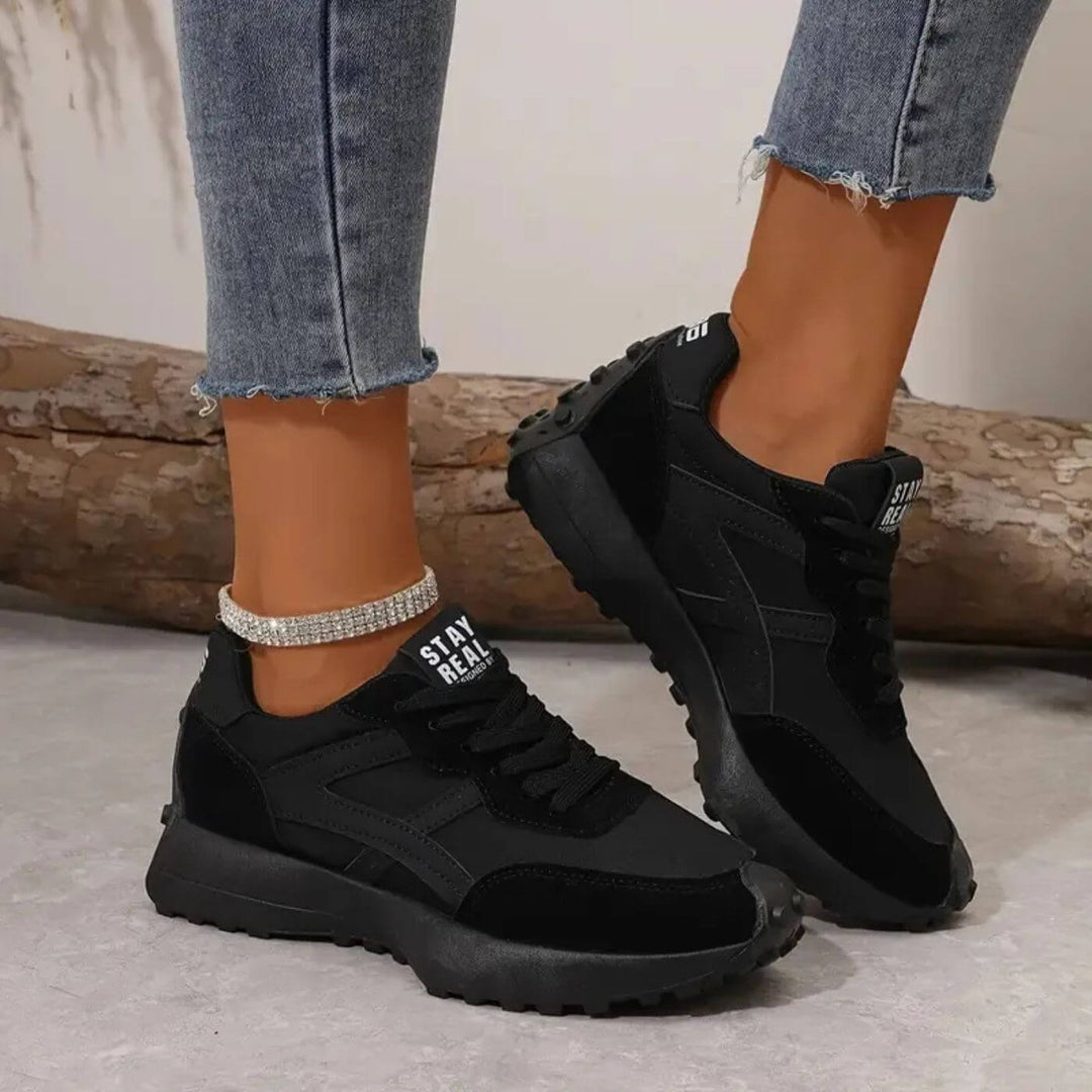 Female model showing slip-on shoes with feet on a plain background.