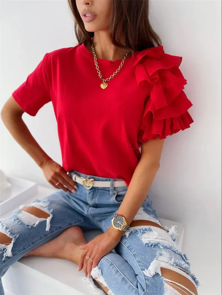 Women’s ruffle sleeve top on a clean background with a feminine structured silhouette.