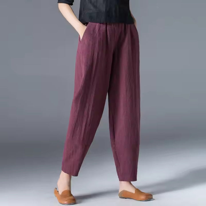 Lightweight relaxed trousers for women on a plain background with easy movement.