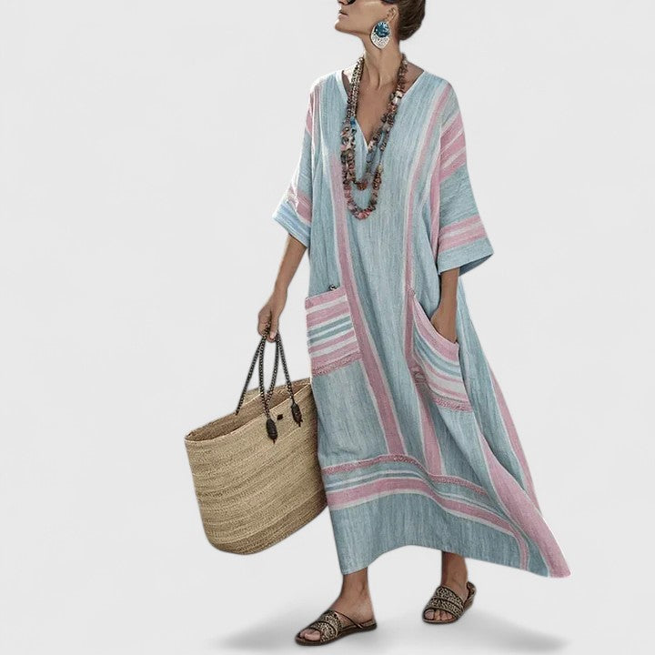 Women’s vacation-ready long dress displayed on a plain background with teal trim and easy movement.