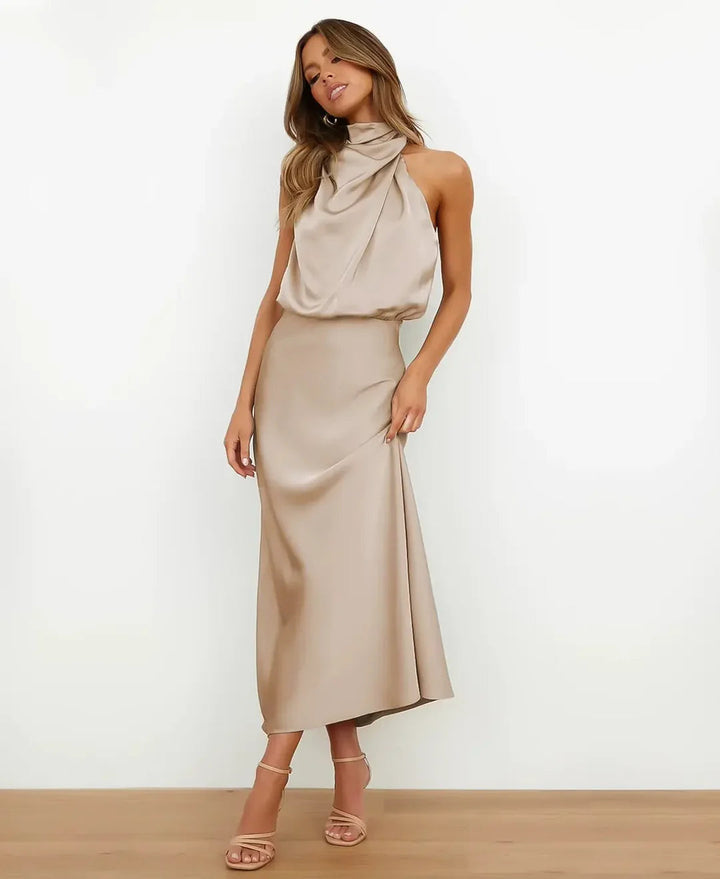 Female model wearing a high waist sleeveless midi dress on a plain background.