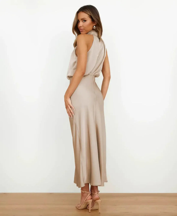 Woman in a high neck midi dress with a clean plain background.