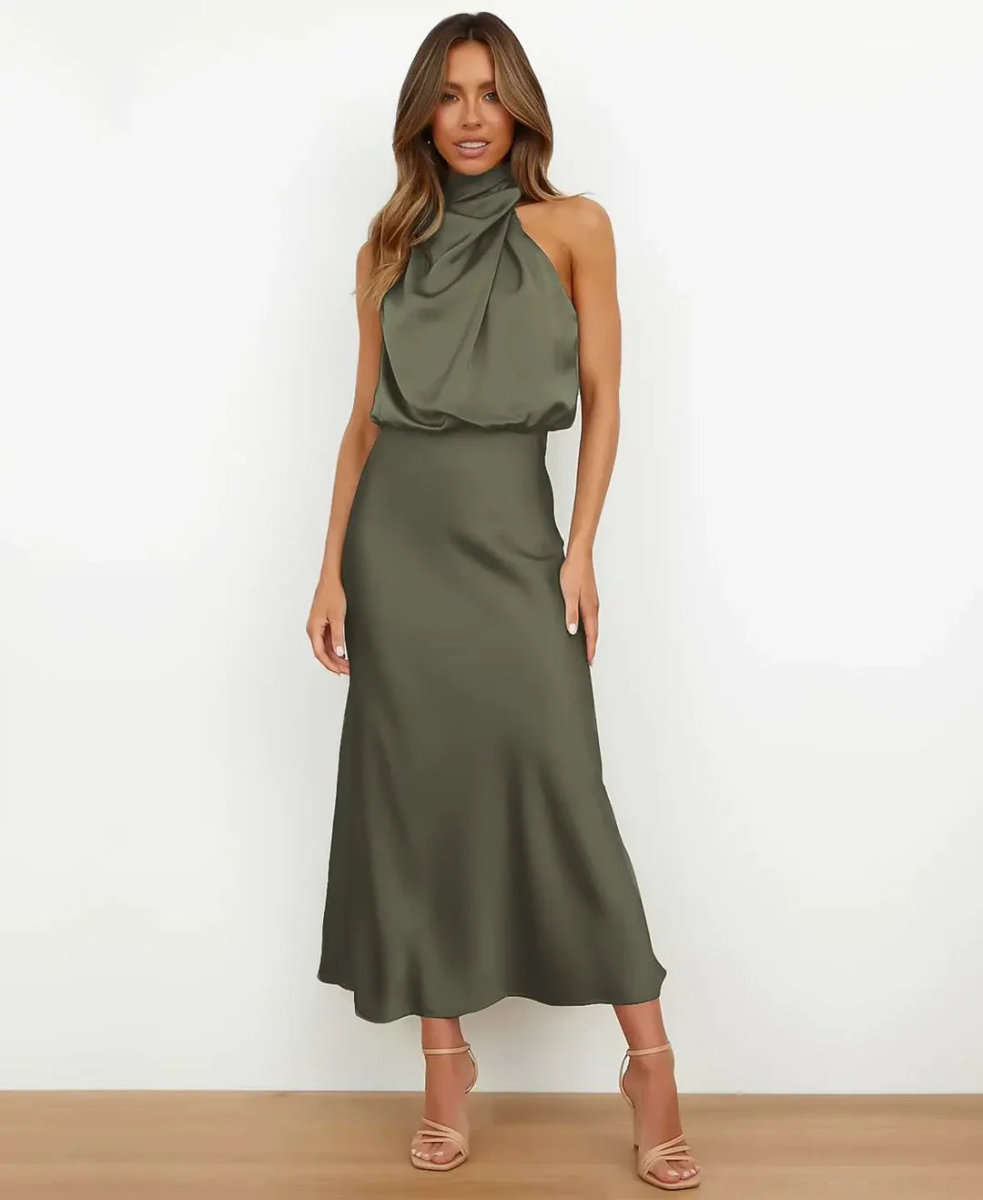 Woman in a high waist dress with a simple plain background.