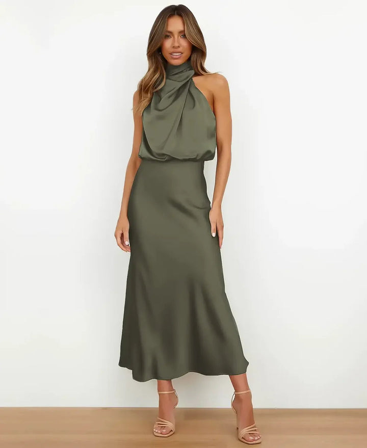 Woman in a high waist dress with a simple plain background.