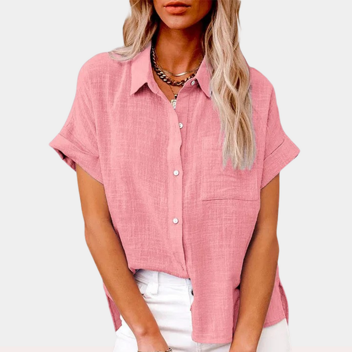 Woman wearing a chic soft shirt with easy drape against a plain background.