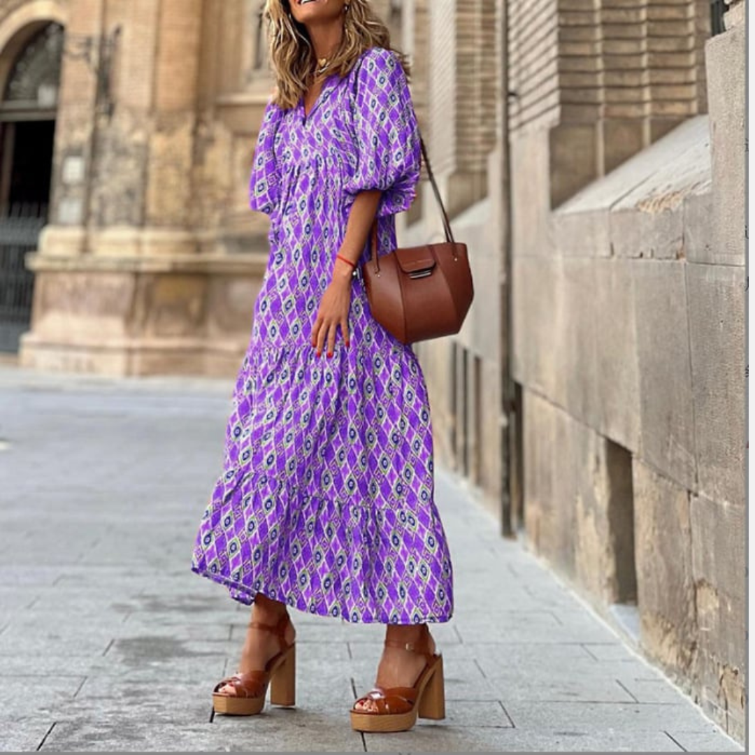 Geometric print maxi dress styled on a woman with neutral plain background.