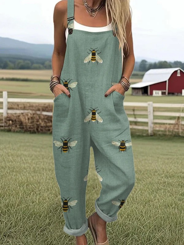 Female model wearing a colorful floral jumpsuit against a plain background.