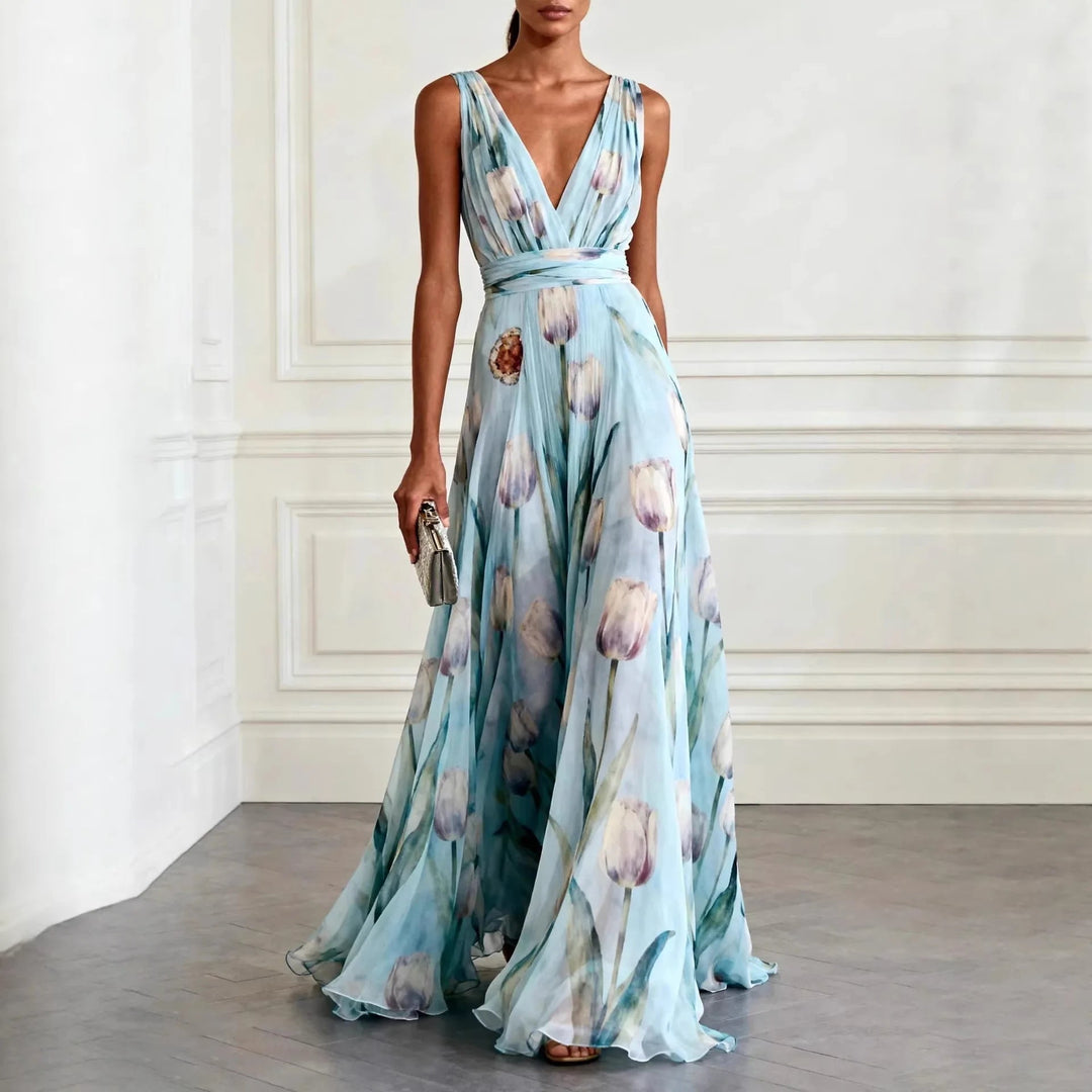 Female wearing a sleeveless tulip print maxi dress on a plain background..
