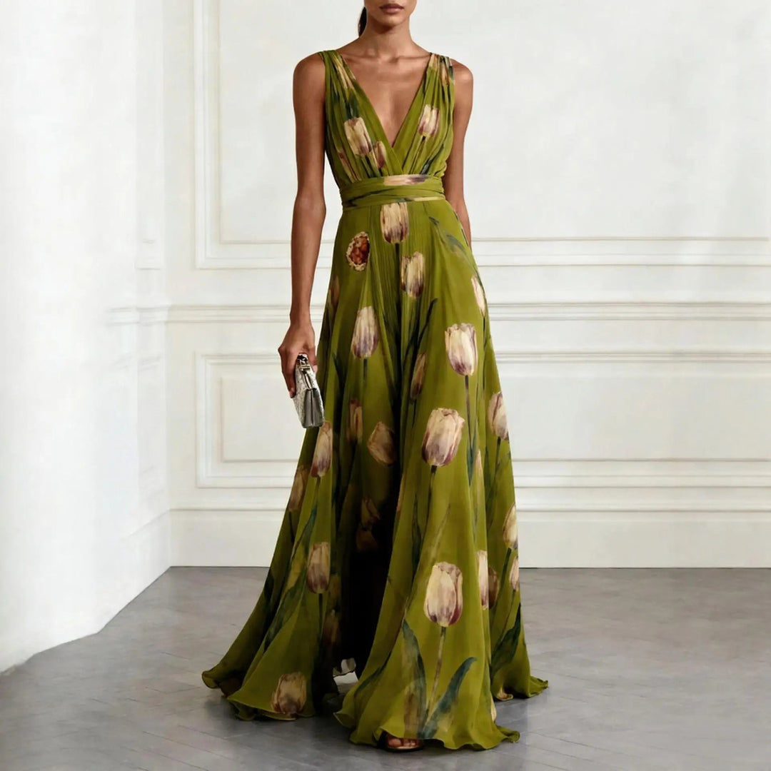 Female wearing an elegant sleeveless floral gown on a plain background