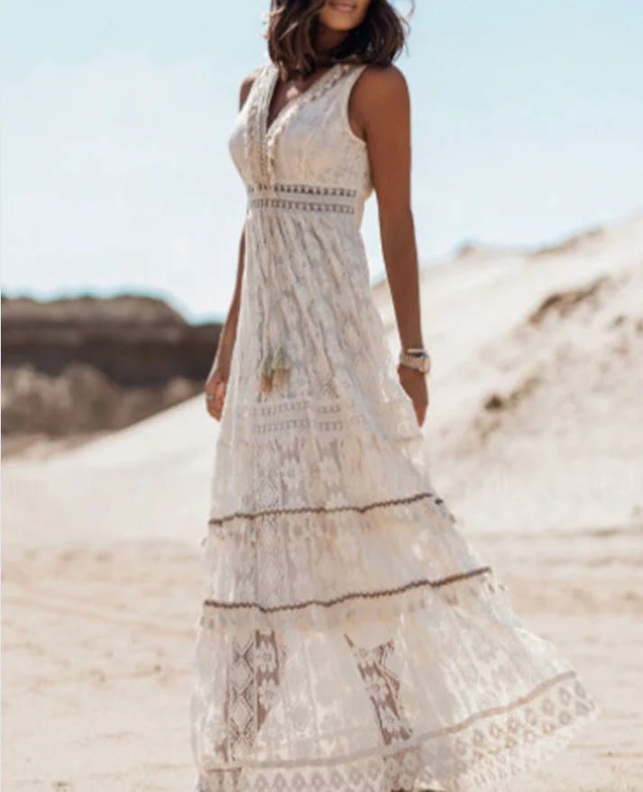 Female model in a tassel waist maxi dress with a soft flowing silhouette.
