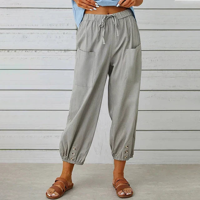 Woman wearing relaxed high rise pants on a clean background.