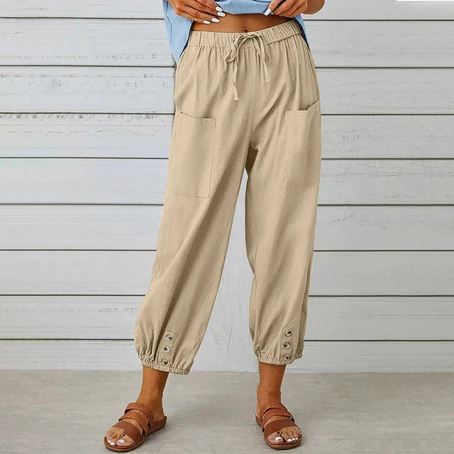 Woman posing in high waist casual pants on a clean background.