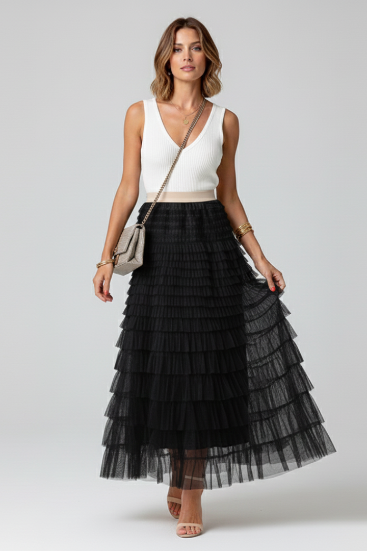 Female model displaying black skirt movement on gray background