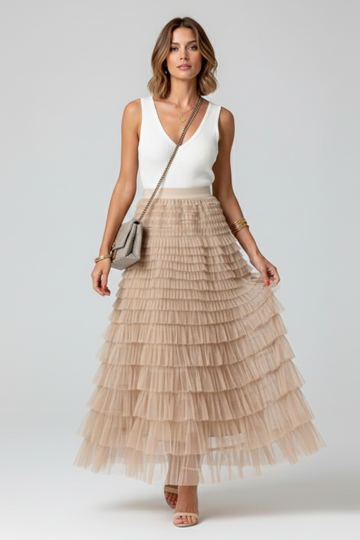 Female model with sling wearing tulle midi skirt ang white top in front view