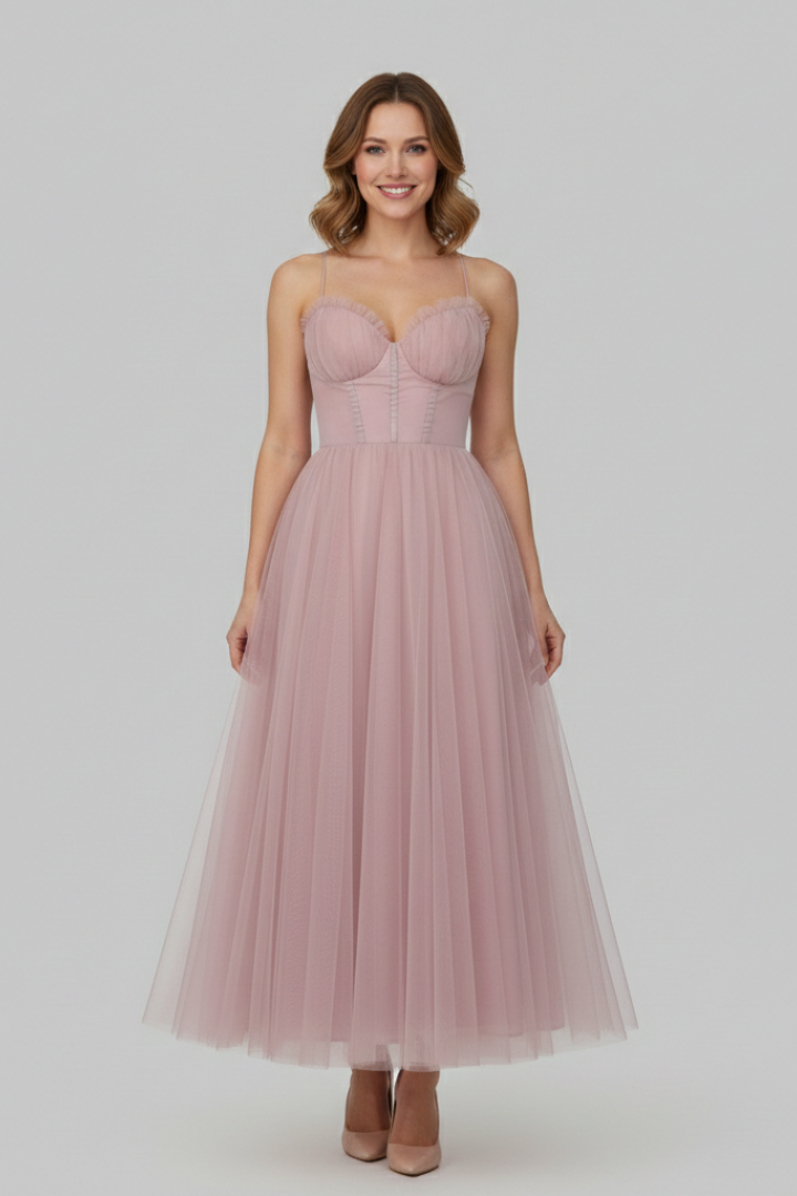 Full length model in strapless dress on pink background