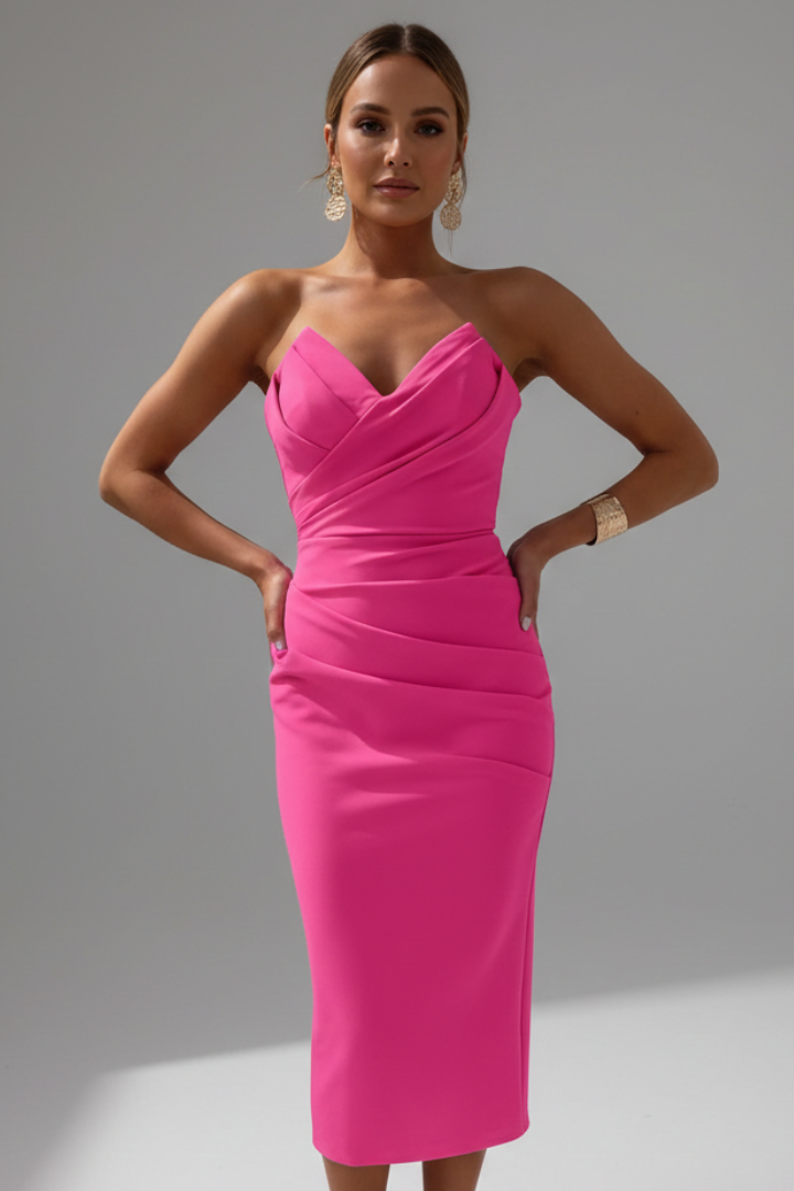 Fashion model in body hugging midi pink dress gray backdrop