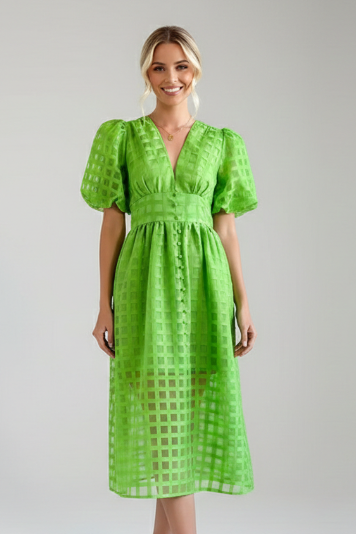 Lace skirt detail on women’s green dress with woman model