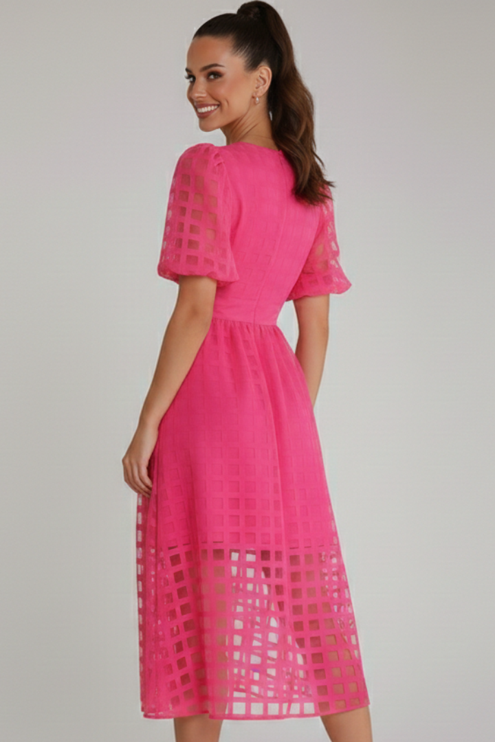 Back view of elegant midi pink dress on model in gray background