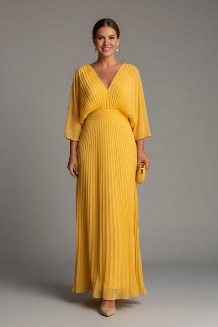Model showing side profile of pleated yellow dress