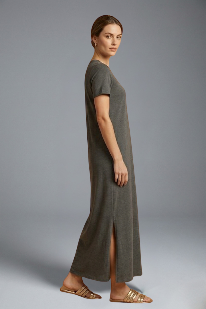 Woman side pose long dress on clean gray background