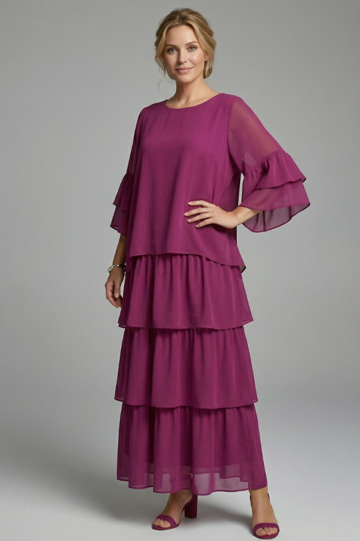 Side angle relaxed tiered dress on gray background