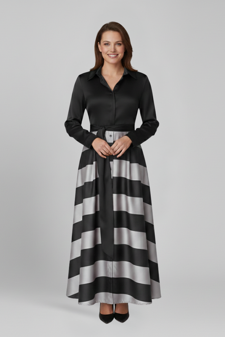Female model wearing belted striped dress, full view, gray background.