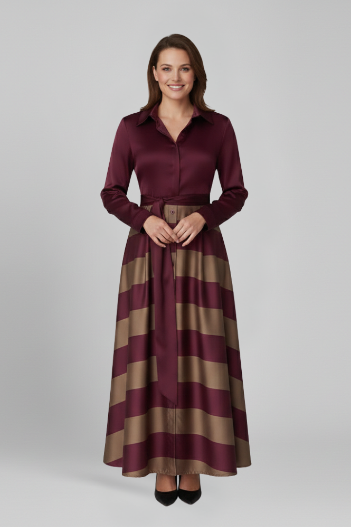 Woman wearing striped maxi dress, front pose, plain gray background.