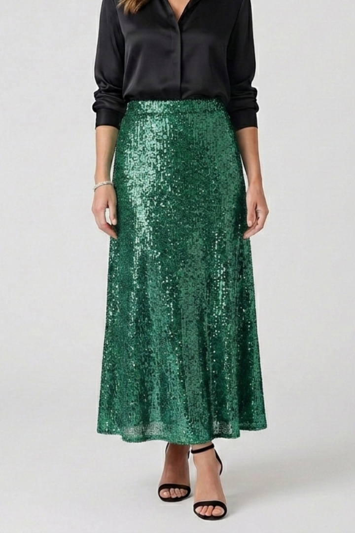 Model in shimmering sequin green skirt with black top waistband close-up gray background