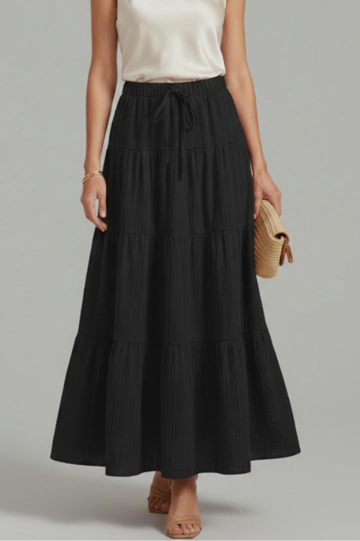 Woman layered black skirt front view on gray background