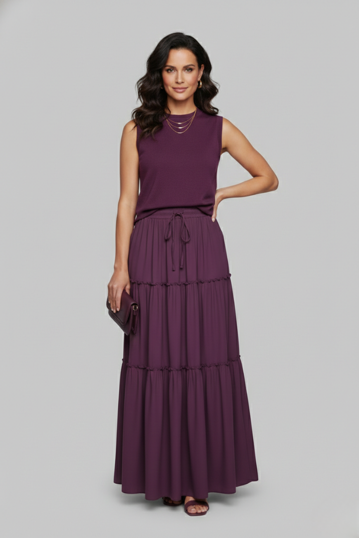 Model standing layered skirt in gray background full length