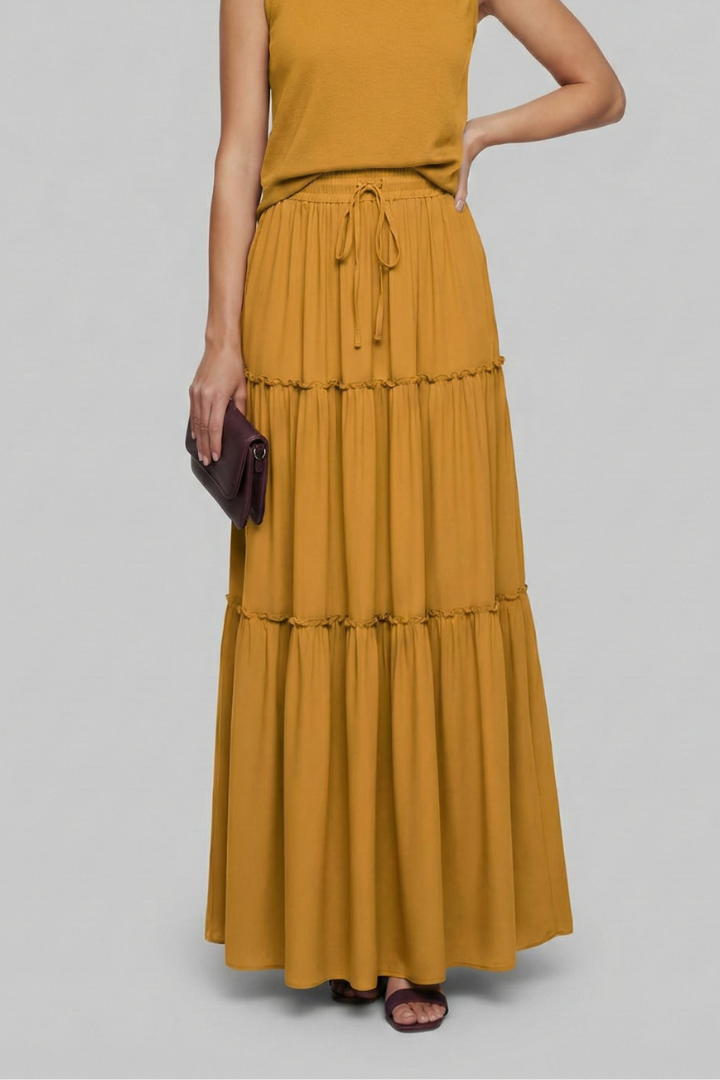 Model minimal pose long yellow skirt gray background studio