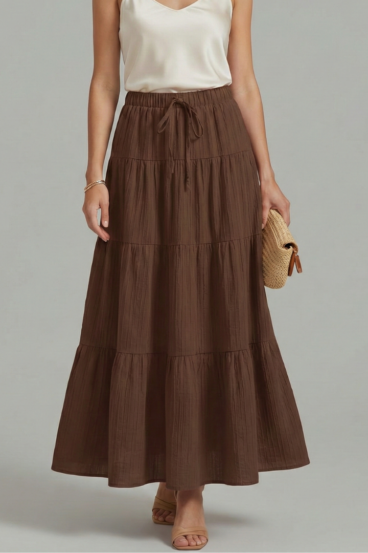 Plain woven long brown skirt front gray background