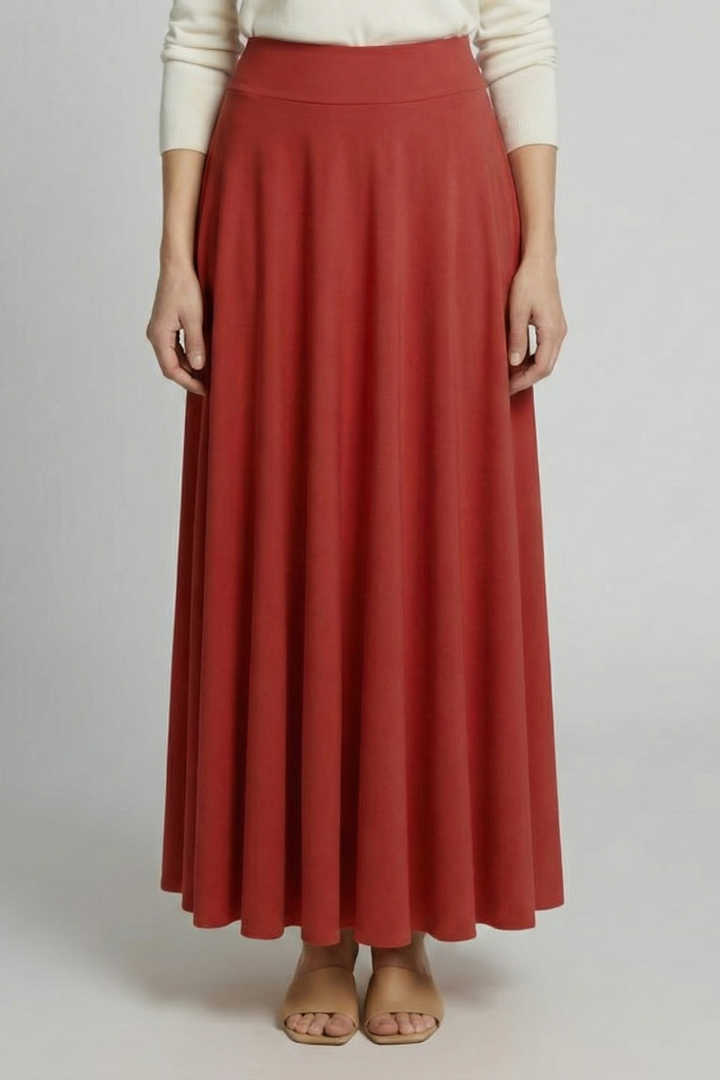 Minimalist studio shot long red skirt model gray backdrop