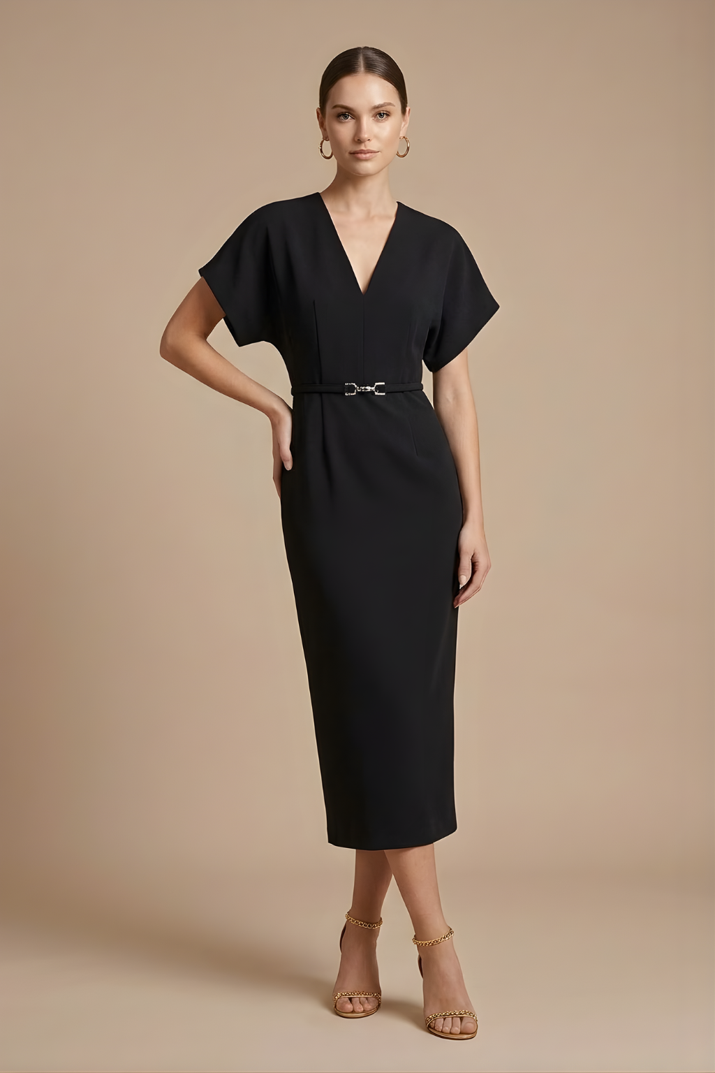 Female model in a chic belted midi dress with relaxed sleeves against a plain background.