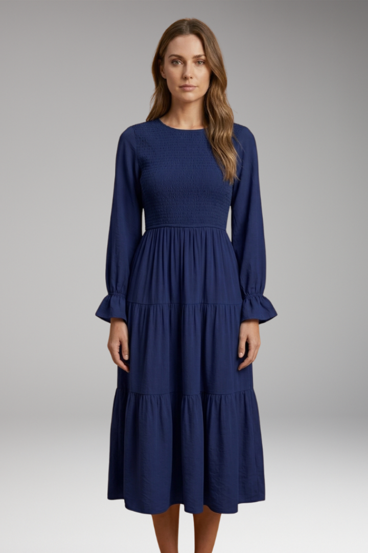 Model in modest tiered dress front facing studio photo