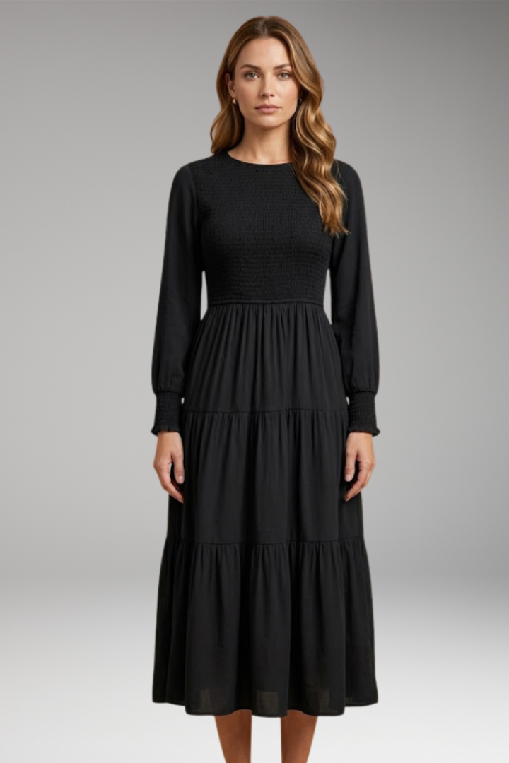 Long sleeve tiered black dress front view neutral background