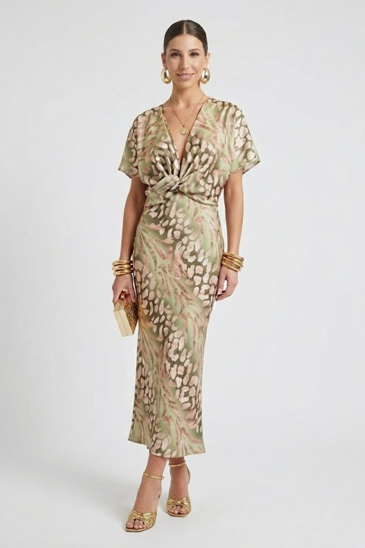 Female model posing in floral midi dress gray background