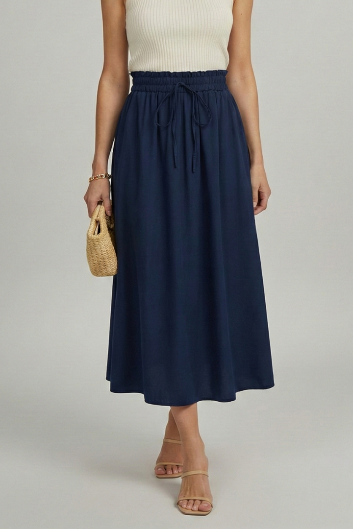 Model with woden bag wearing fashionable navy midi skirt clean studio product display