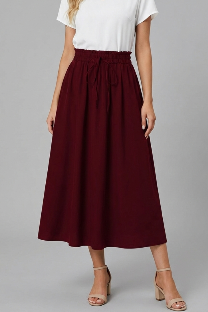 Trendy women’s red midi skirt on plain white backdrop