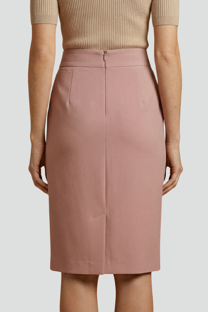 Neutral pink pencil skirt with back slit back view studio background
