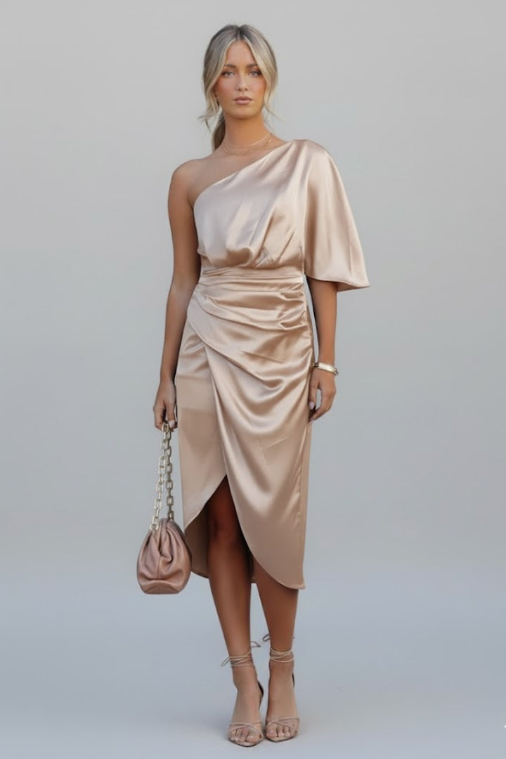 Female model showing shaped waist dress on plain gray background.