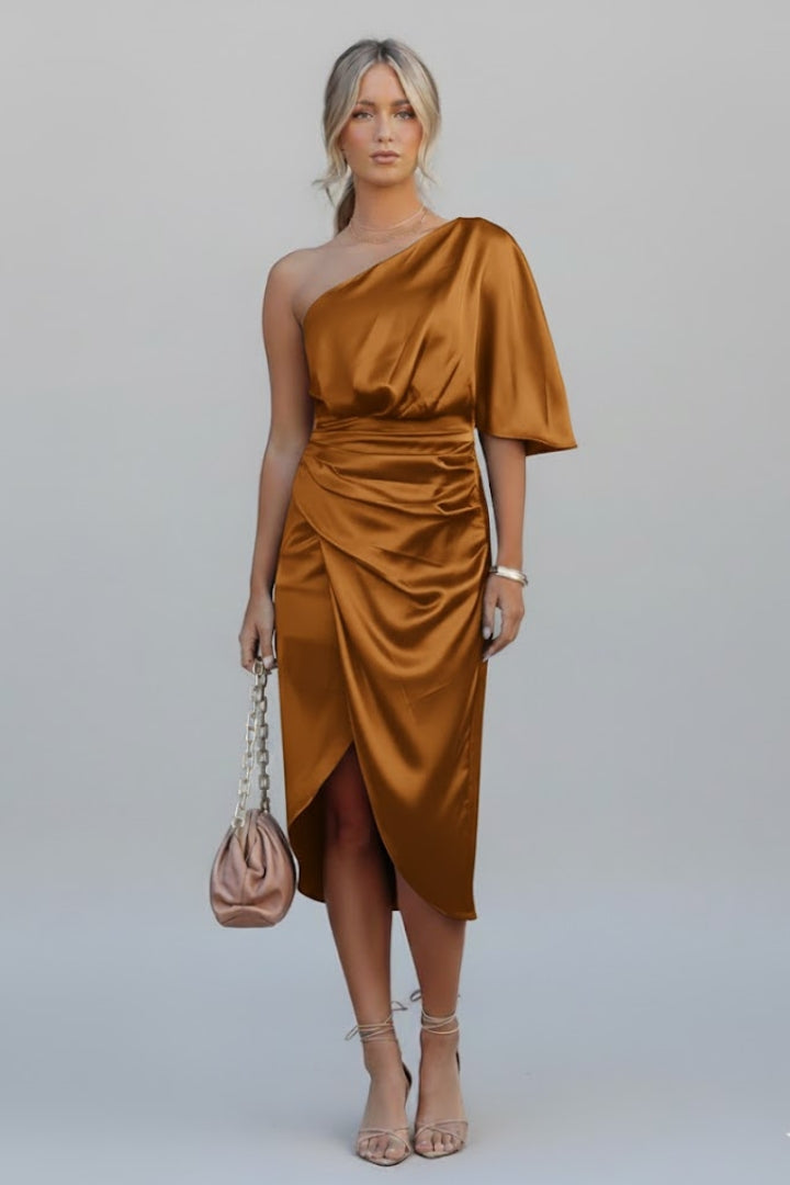 Female model wearing midi dress from back angle, plain gray background.