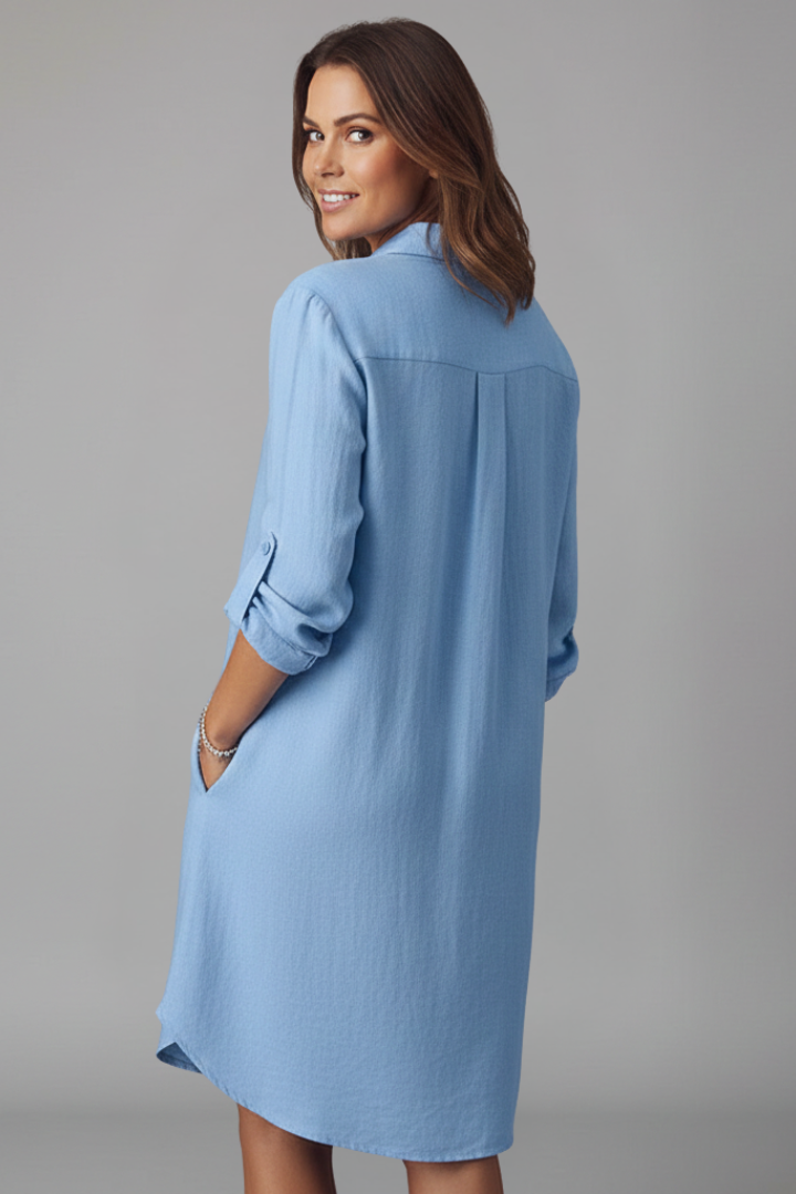  Female in a long sleeve button-down dress featuring a straight silhouette on a plain background.