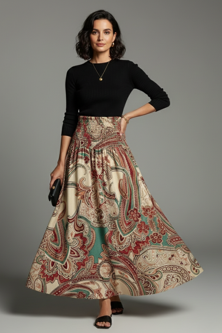 Model with clutch, necklace and sandal and in full length skirt with black long sleeve top
