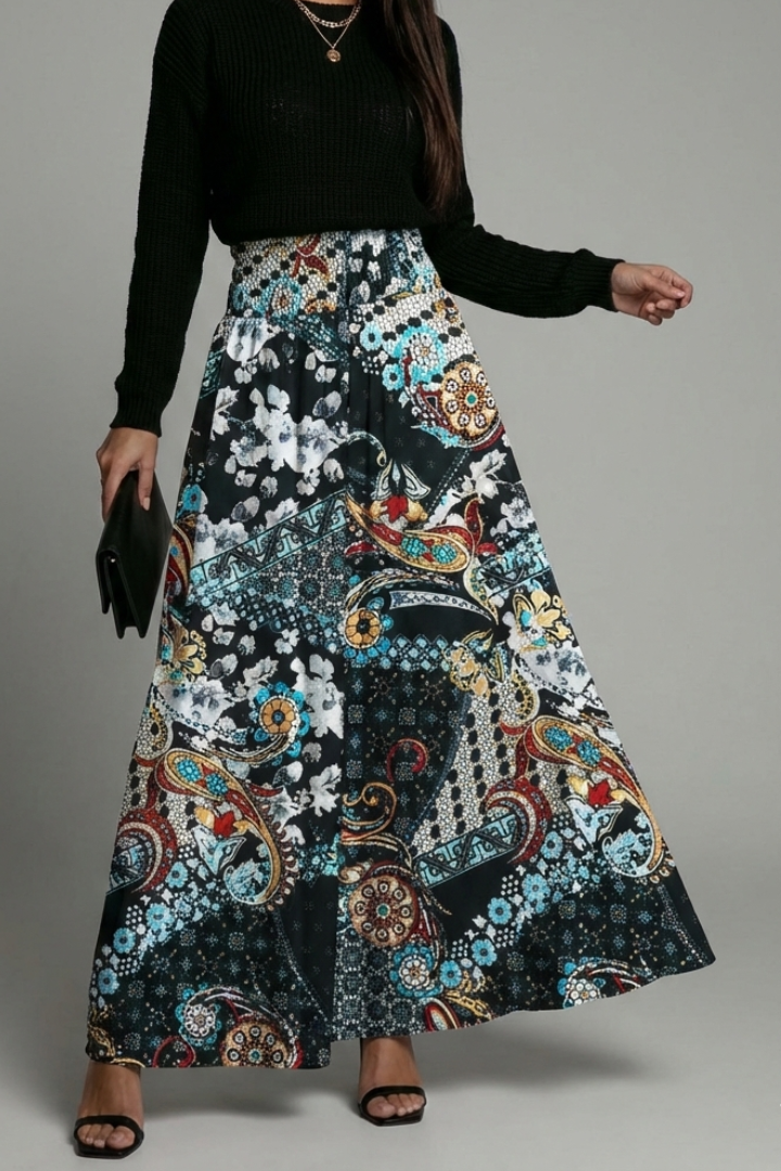 Model with clutch wearing multicolor skirt silhouette front angle on neutral background