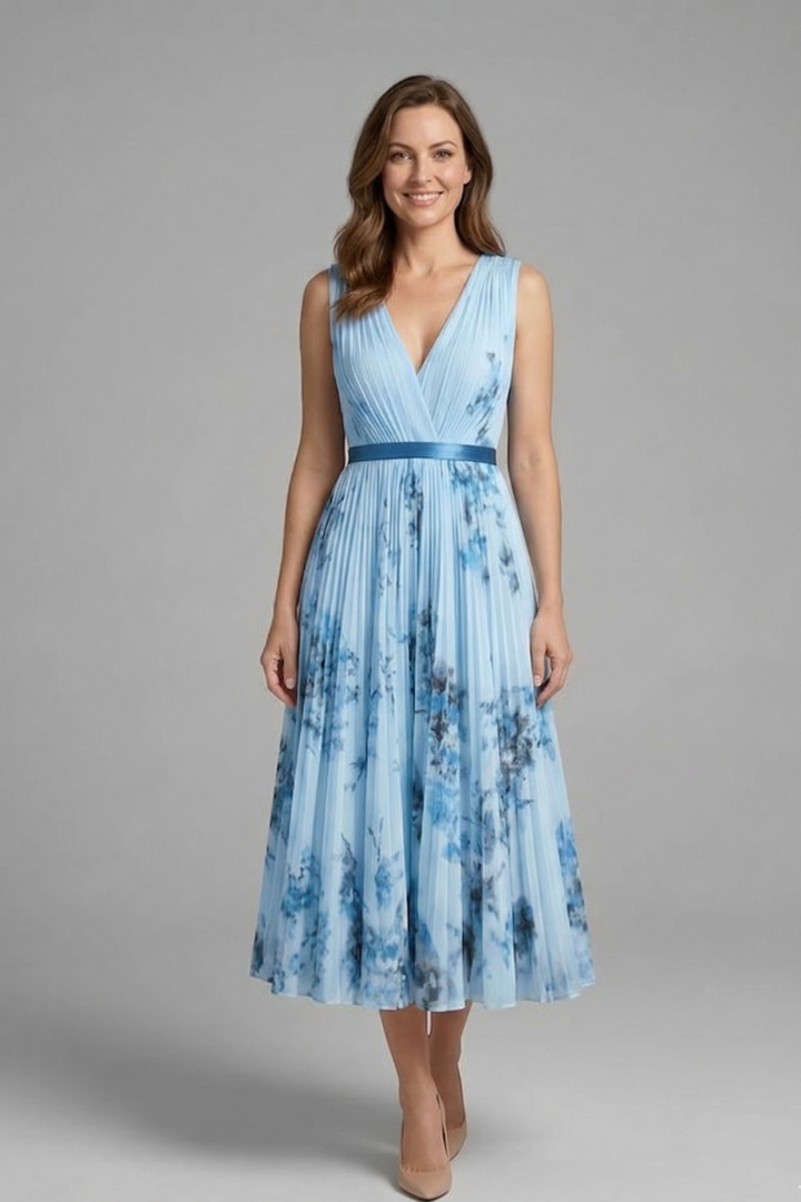 Elegant model fashion pose in blue dress gray background