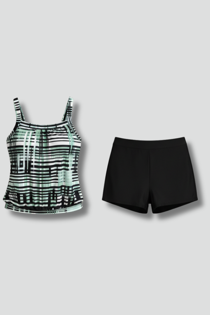Woman wearing striped swim set front view on plain gray background.