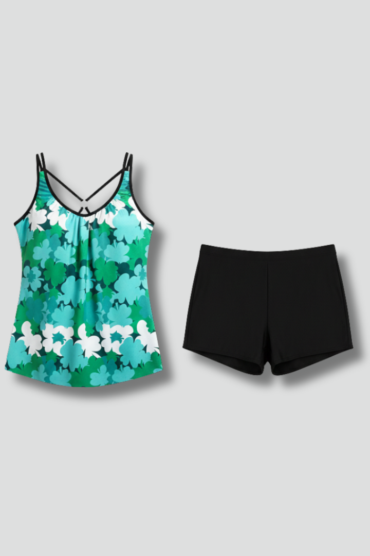 Woman wearing printed tankini set front view on plain gray background.