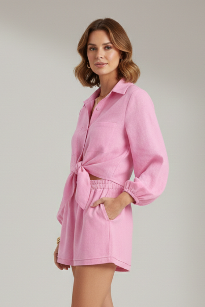 Model side angle pink dress on plain gray background