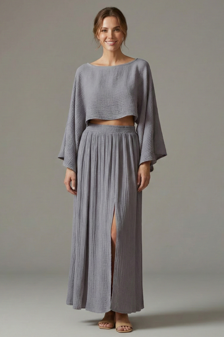 Model in elegant textured outfit gray background